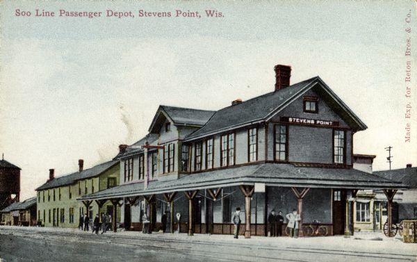 View across railroad tracks towards the Wisconsin Central railroad station. Caption reads: "Soo Line Passenger Depot, Stevens Point, Wis."