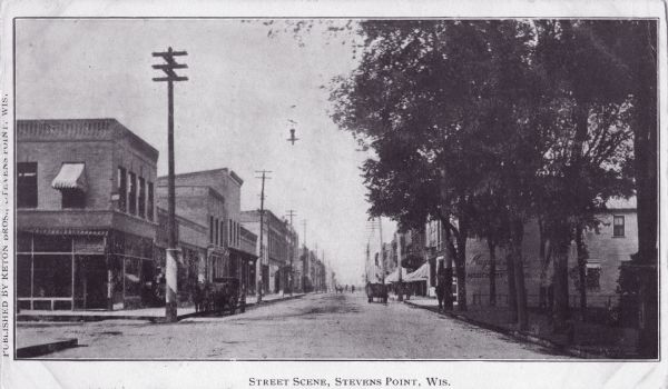 View of a street scene in downtown Stevens Point. Caption reads: "Street Scene, Stevens Point, Wis."