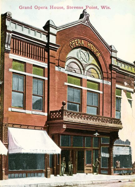 Exterior view of the opera house with several men standing near its entrance. Caption reads: "Grand Opera House, Stevens Point, Wis."