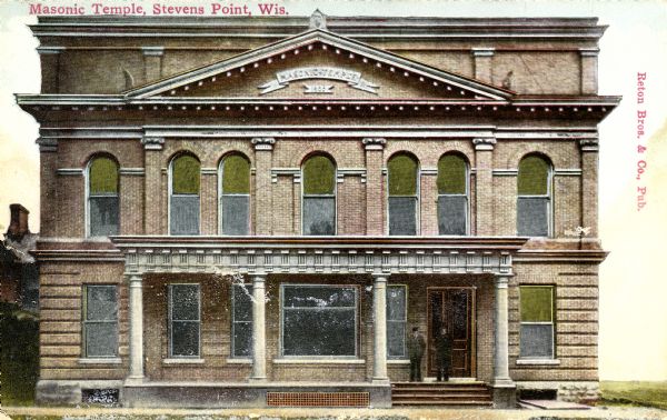 Exterior view of a Masonic temple with two figures standing near its front door. Caption reads: "Masonic Temple, Stevens Point, Wis."