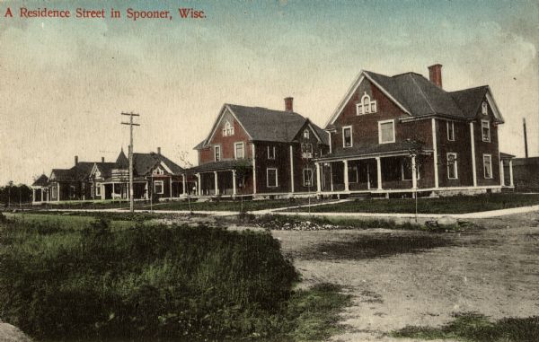 View of a residential street. Caption reads: "A Residence Street in Spooner, Wisc."