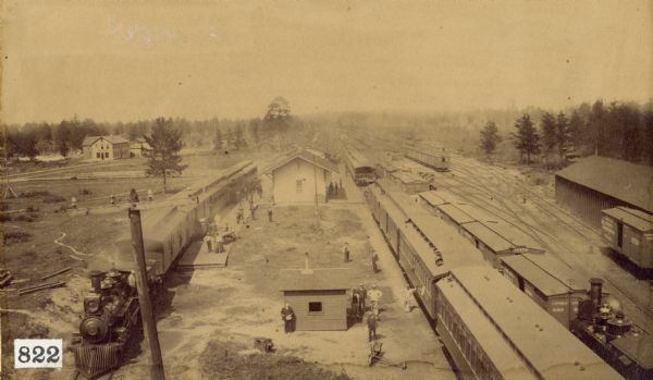 Elevated view of a railroad station and yards.