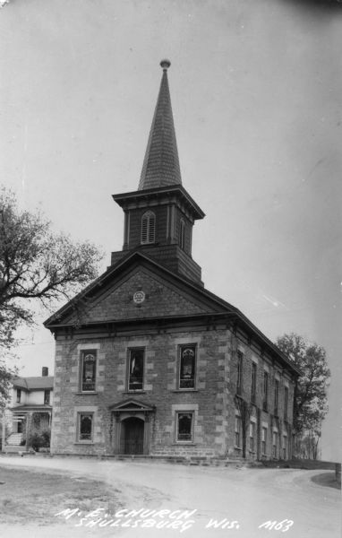 Exterior view of the church. Caption reads: "M.E. Church, Shullsburg, Wis."
