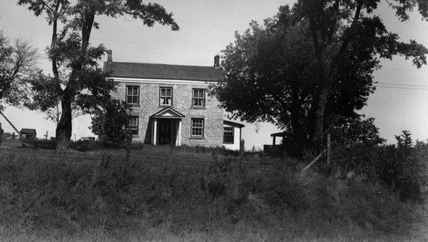Exterior view of a farmhouse in the vicinity of Shullsburg, "typical of early stone houses in southwestern Wisconsin."