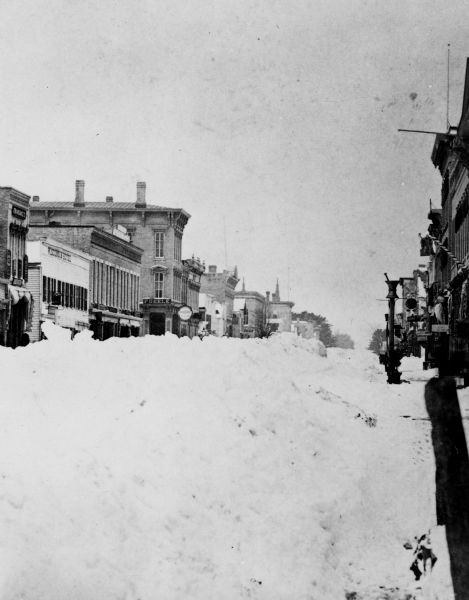 Winter scene of a commercial street after the "big snow" of 1881, Sheboygan, Wisconsin.