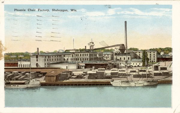 View across water towards the Phoenix Chair factory on the waterfront. Caption reads: "Phoenix Chair Factory, Sheboygan, Wis."