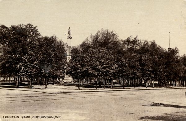 View across street towards of Fountain Park. Caption reads: "Fountain Park, Sheboygan, Wis."