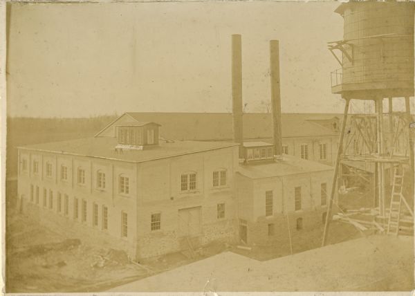 Elevated view of the Wolf River Paper Company factory, including smokestacks and a water tower.