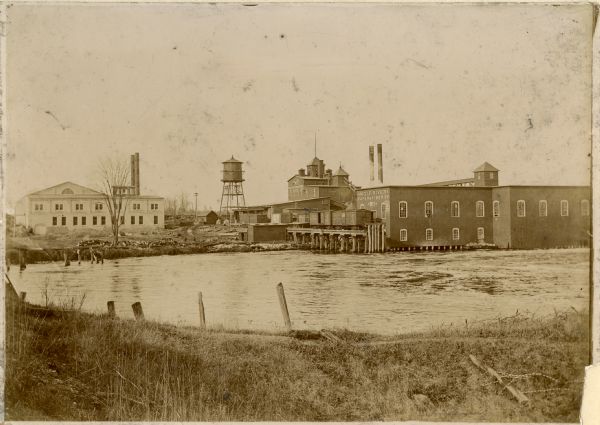 View from shoreline towards the opposite shoreline of the Wolf River Paper Company factory complex on the Wolf River.