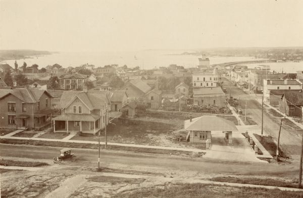 Elevated view of various buildings with Sturgeon Bay in the background.