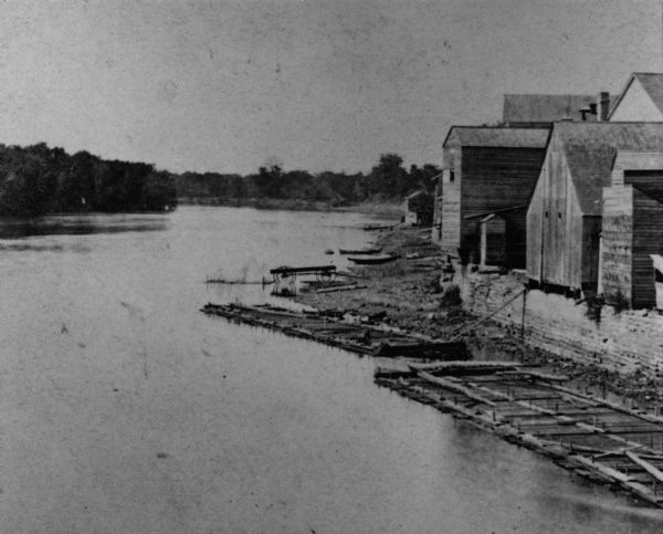 Elevated view of the Wisconsin River shoreline, showing lumber rafts "tied up over Sunday."