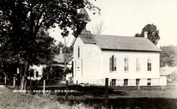 Exterior view of a Baptist church. Caption reads: "Russell Baptist Church".