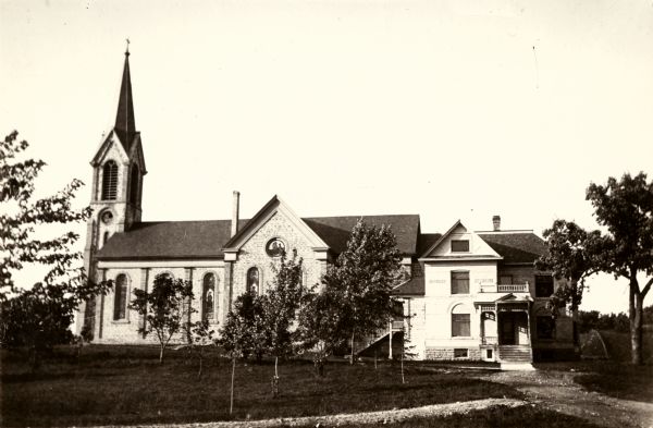 Exterior view of St. Norbert's Society church and parsonage.