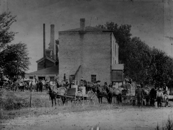 Men and boys with wagonloads of milk at the Rockdale Creamery.