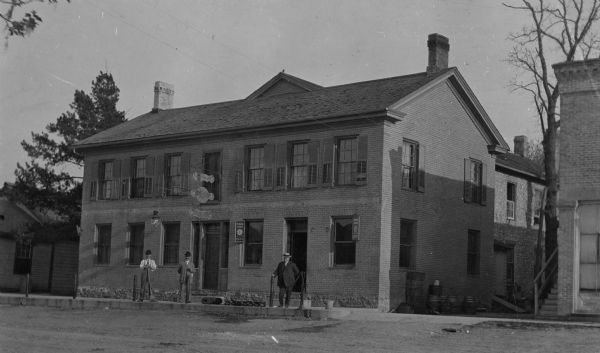 Exterior of the Union House. Three men are standing on the sidewalk in front.