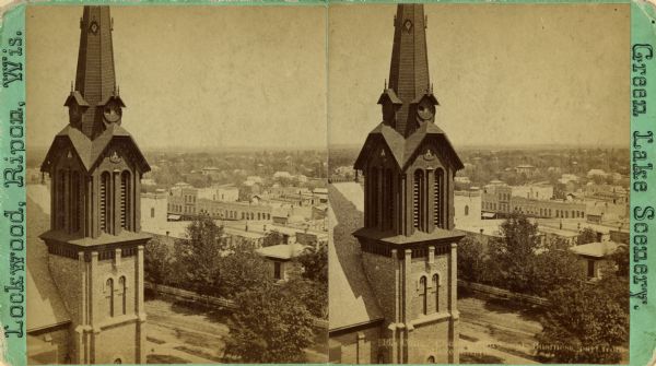 Elevated stereograph view of the business district, with the spire of the Congregational Church in the foreground.