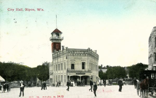 Street scene surrounding City Hall, with pedestrians walking on the street. Caption reads: "City Hall, Ripon, Wis."