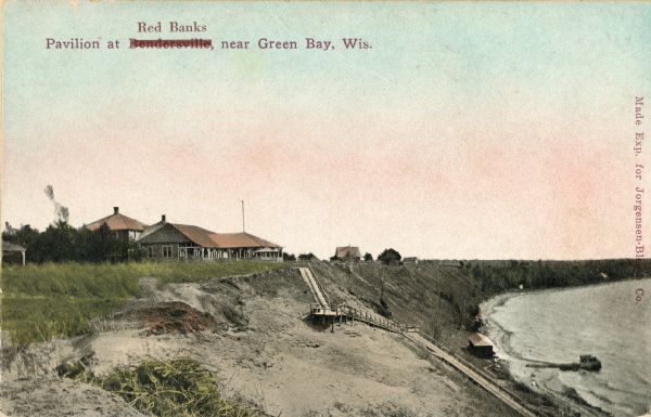 Walkway on the bluff leading down to a pavilion on the shoreline. Houses are in the background. Caption reads: "Pavilion at Bendersville, near Green Bay, Wis." Bendersville has been crossed out and replaced with Red Banks.