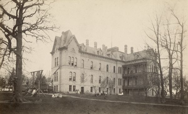 The Taylor Orphan Asylum, view from the rear. Children are playing on the lawn in front.
