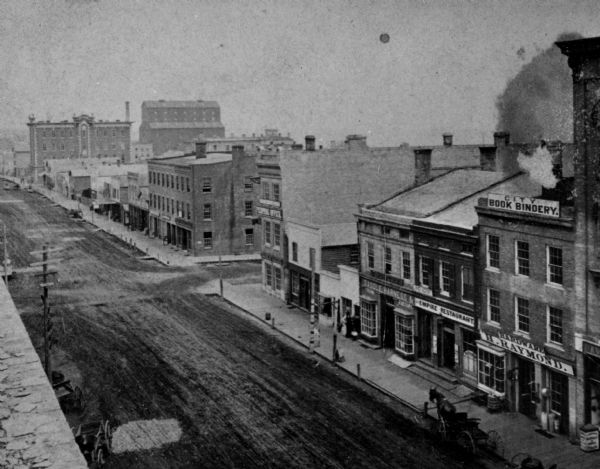 Elevated view of east side of Main Street, with Raymond & Jones Hardware visible at 112 Main Street.