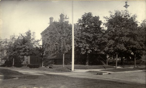 Exterior view of the residence of Chauncey Hall. A street light is suspended over the the street on the right.