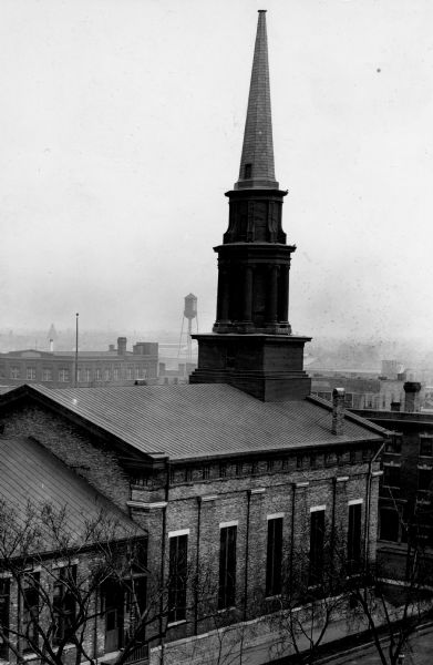 Elevated view of the First Presbyterian Church from the southeast. A water tower is in the background.
