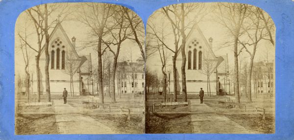 Stereograph of a chapel on the campus of Racine College with a man standing in front of it.