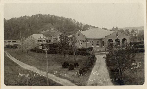 Elevated view of Home store, Prairie Farm. Includes additional buildings. Caption reads: "Home Store Prairie Farm Wis."