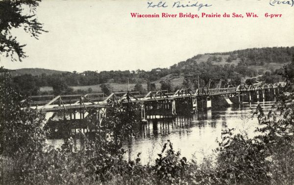 This was the first bridge built across the Wisconsin River, constructed about 1850, although it was not opened to traffic until 1852. It was torn down in 1921. Caption reads: "Wisconsin River Bridge, Prairie du Sac, Wis. 6-pwr".