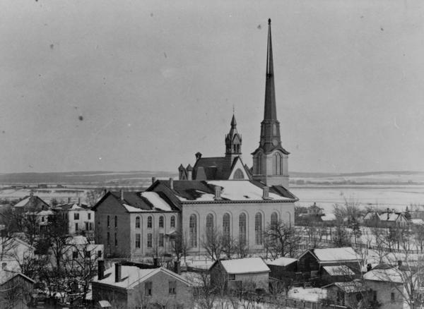 Elevated view over houses towards the First Congregational Church in winter.