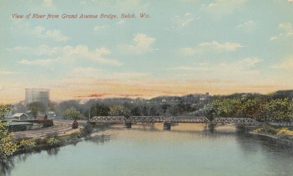 Elevated view of the river, with railroad tracks on the left shoreline, and a railroad bridge crossing the river. Caption reads: "View of River from Grand Avenue Bridge, Beloit, Wis."