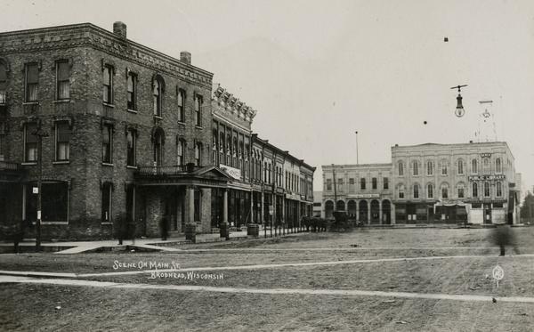 View of Main street with the public library and storefronts.