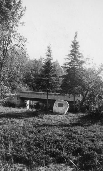 View of bridge and Brule River monument. Placed where the Brule River is crossed by the Memorial Highway from Superior to Brule and Ashland (Highway 2).