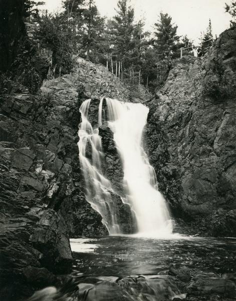 View from rocky shoreline towards the Brownstone Falls in Copper Falls State Park.