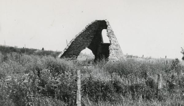 Charcoal kiln in an overgrown field. Producing charcoal was once a fairly large industry in De Pere.