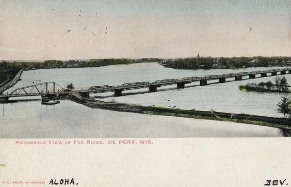 Caption reads: "Panoramic View of Fox River, De Pere, Wis." Elevated view of the bridge crossing over the Fox River near De Pere.