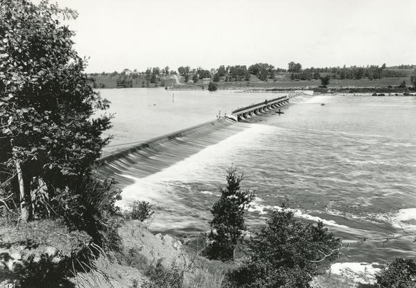 Elevated view down hill of the Fox River and the Little Rapids dam.