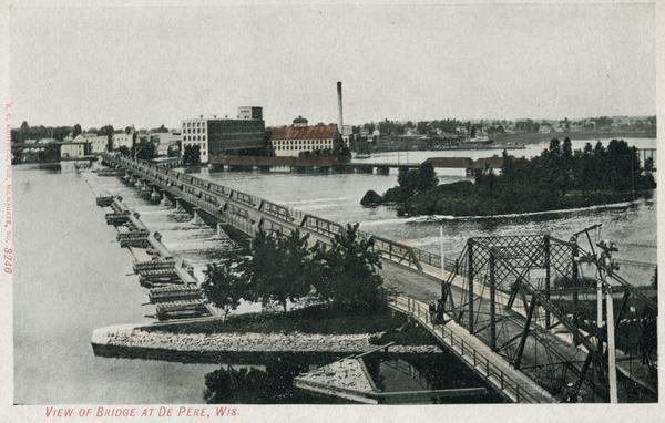 Elevated view of the bridge over the Fox River at De Pere. Caption reads: "View of Bridge at De Pere, Wis."
