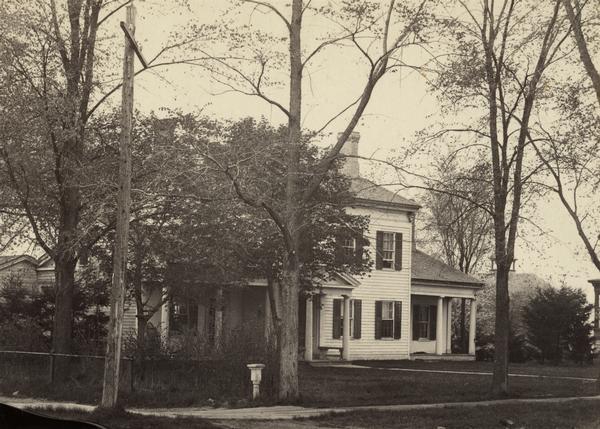 Randall Wilcox's home, with trees and a sidewalk, built in 1836 or 1837.