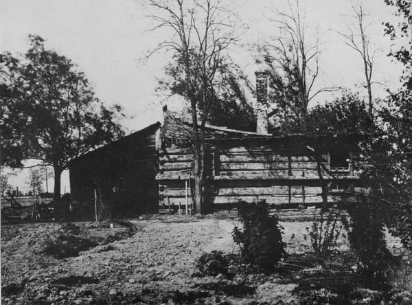 Eleazer William's log cabin, five miles south of De Pere, overlooking the rapids of the Little Bakalin on the Fox River.