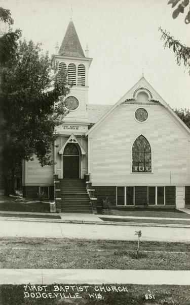 Front exterior view of the First Baptist Church with stained glass windows.