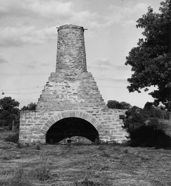 Large brick kiln-like structure in field. Built in 1876, the blast furnace was used to salvage additional lead from the slag of 18 area furnaces operating in Dodgeville and vicinity before the Black Hawk war. It operated until the spring of 1890.