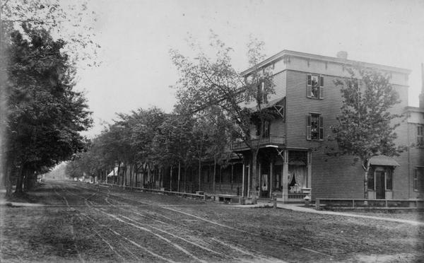 View across unpaved streets towards buildings in Meggett Square and on Barlow Street.