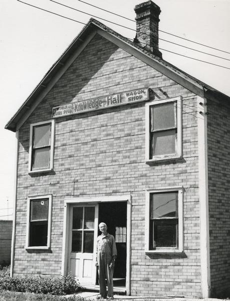 Front entrance to Knowledge Hall, with a man standing on the front walk. This was a wagon shop and GAR meeting hall. It was demolished in 1964.