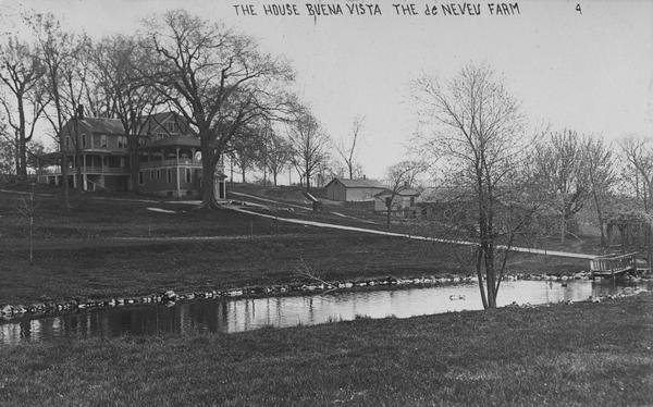View across pond looking towards the Buena Vista house on Lake de Neveu. Caption reads: "The House Buena Vista The de Neveu Farm".
