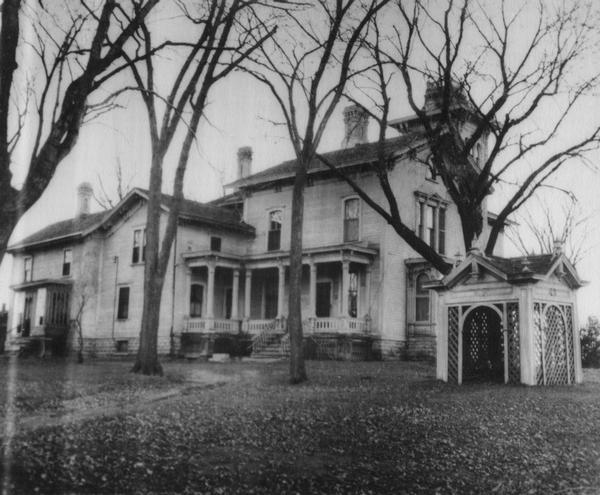 Galloway House, with gazebo on the lawn at right, among bare trees.