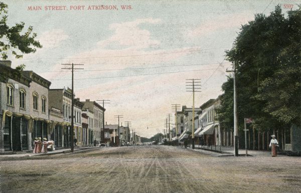 View looking down Main Street with storefronts and telephone lines. Caption reads: "Main Street, Ft. Atkinson, Wis."