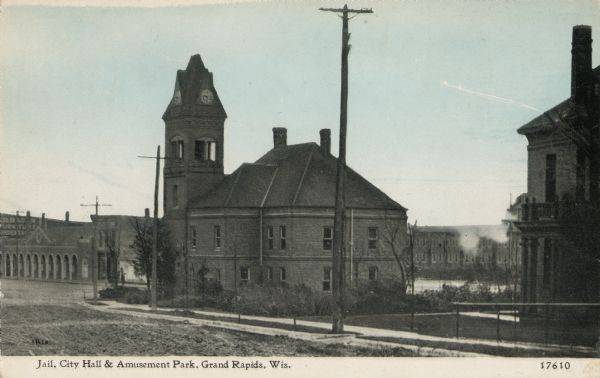 Jail, City Hall, and an amusement park. The Jail was later used as a School and Library. Caption reads: "Jail, City Hall & Amusement Park, Grand Rapids, Wis."