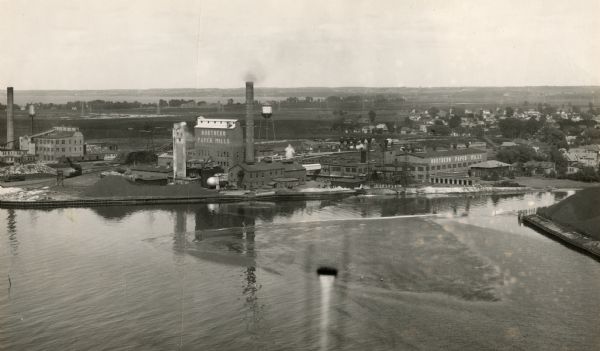 Aerial view of the conluence of the Fox River and the East River.  The Northern Paper Mills are in the foreground and the city is seen to the right.