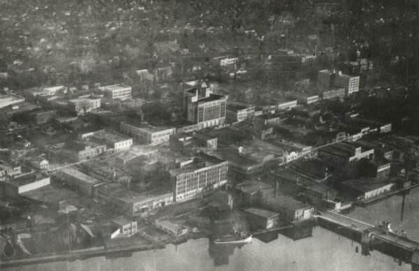 Aerial view of the commercial district on the east side of the Fox River.  Left to right: Hurlbut Coal Company; suggested location for small terminal; Main Street bridge; suggested location for a passenger and package freight terminal.